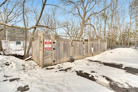 a wooden fence with a no trespassing sign on it